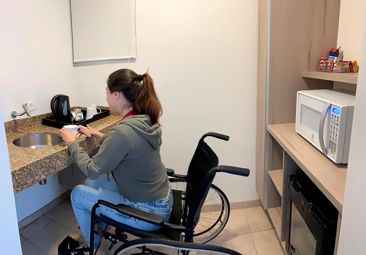 فندق Radisson Oscar Freire ساو باولو المظهر الخارجي الصورة A disabled woman in a wheelchair using a microwave oven